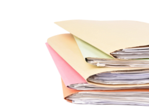 A pile of documents in cardboard wallets.