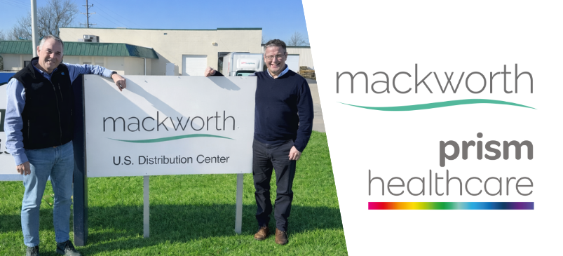 Charley Wallace (President of Mackworth USA) and Tony O-Brien (Group Operations Director, Prism Healthcare) standing next to a Mackworth Distribution sign.